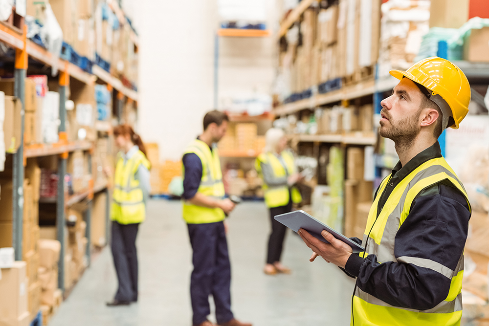 Warehouse workers using devices that are managed and secured by the SOTI ONE Platform