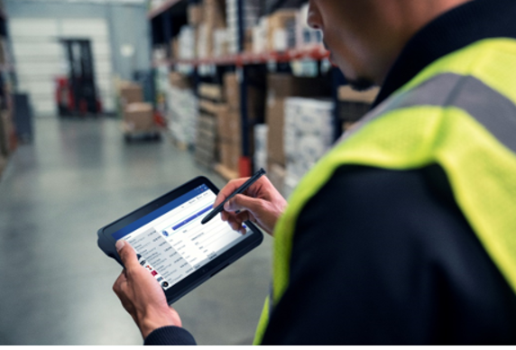 A warehouse worker using a Samsung tablet that is managed and secured by the SOTI ONE Platform